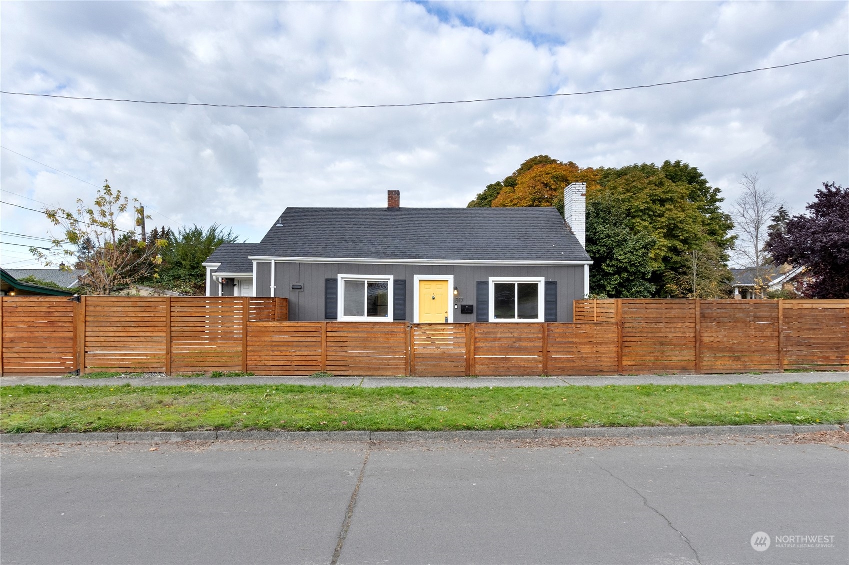 a front view of a house with a garden and plants