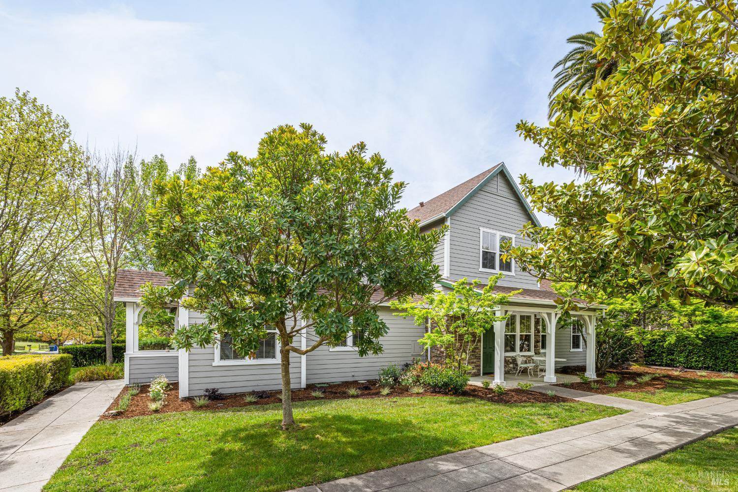 a front view of a house with a yard and green space