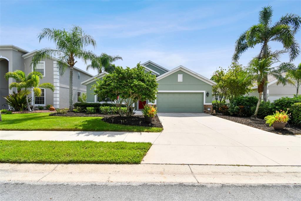 a front view of a house with a yard and garage