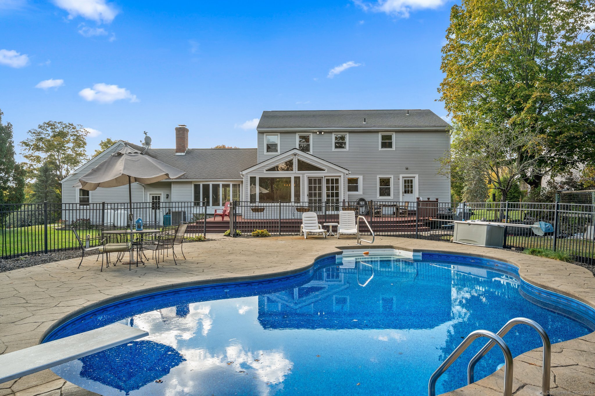 a view of a swimming pool with outdoor seating