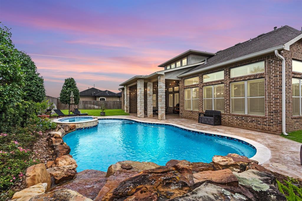 a view of a house with swimming pool and sitting area