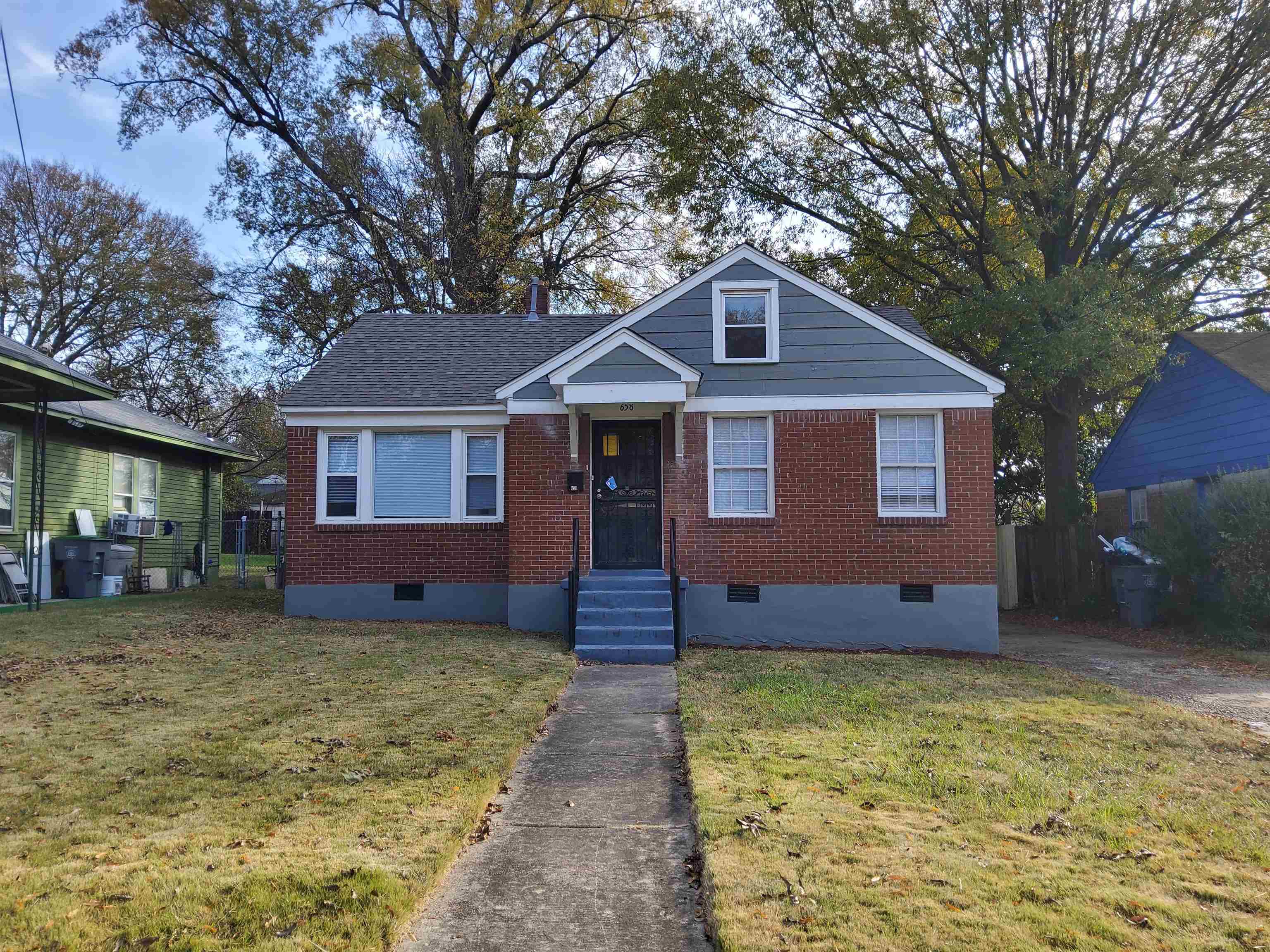 Bungalow-style house with cooling unit and a front yard