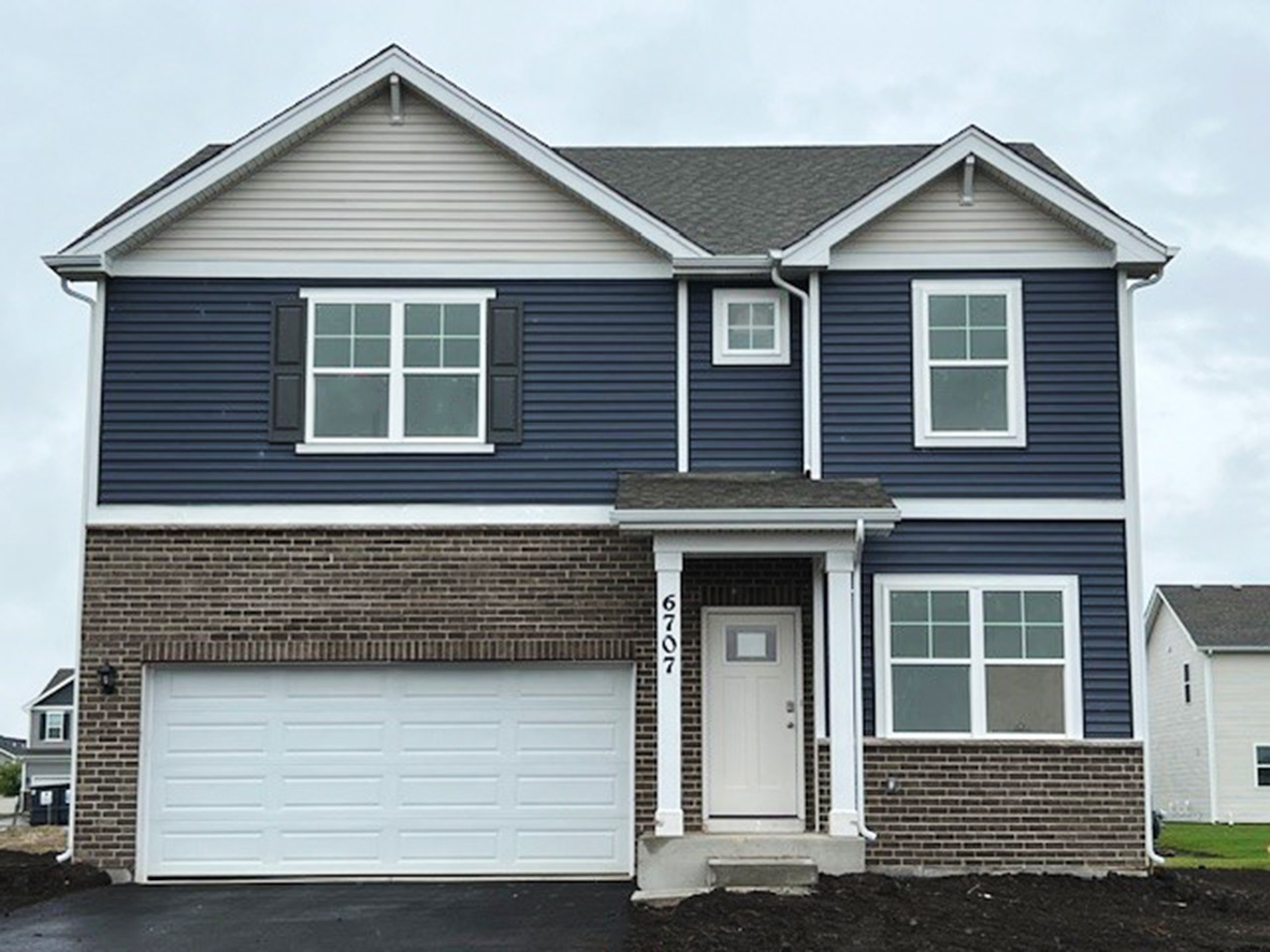 a front view of a house with a garage