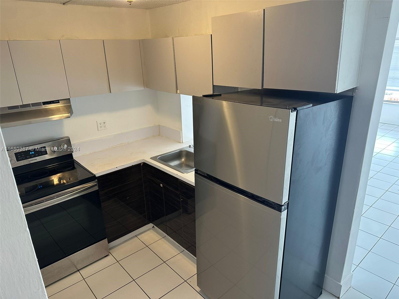 a kitchen with a refrigerator and a stove