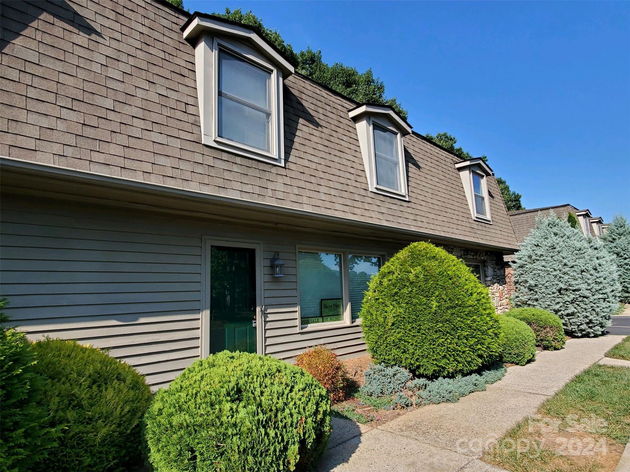 a front view of a house with garden