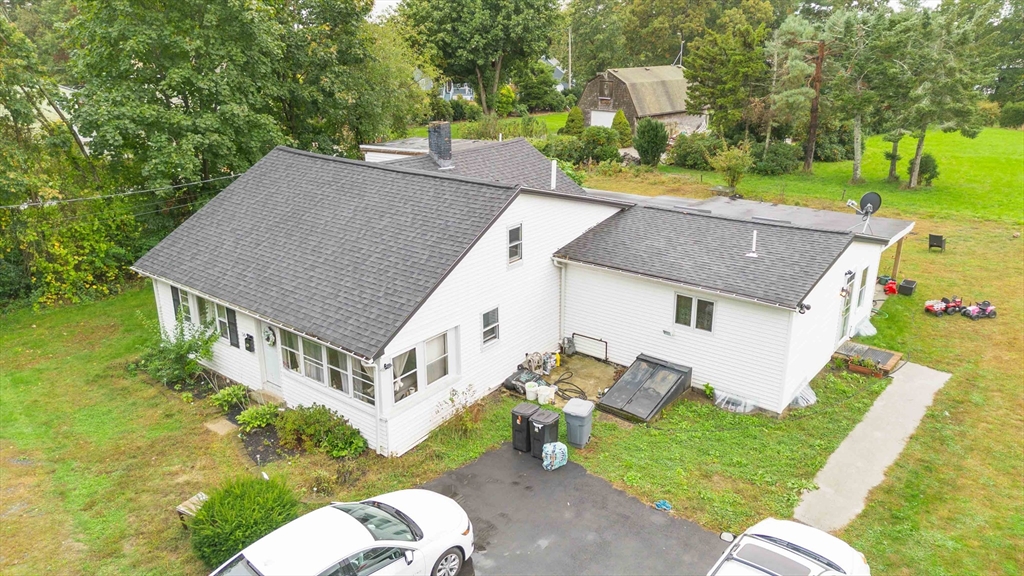 a aerial view of a house with a yard table and chairs