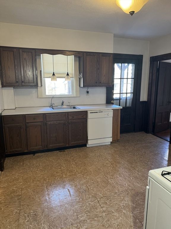 a large kitchen with a window and cabinets