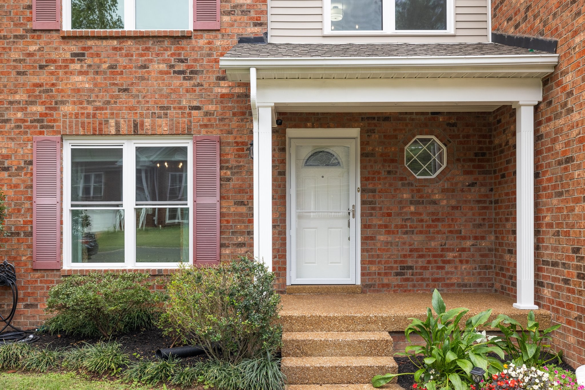 a front view of a house with garden