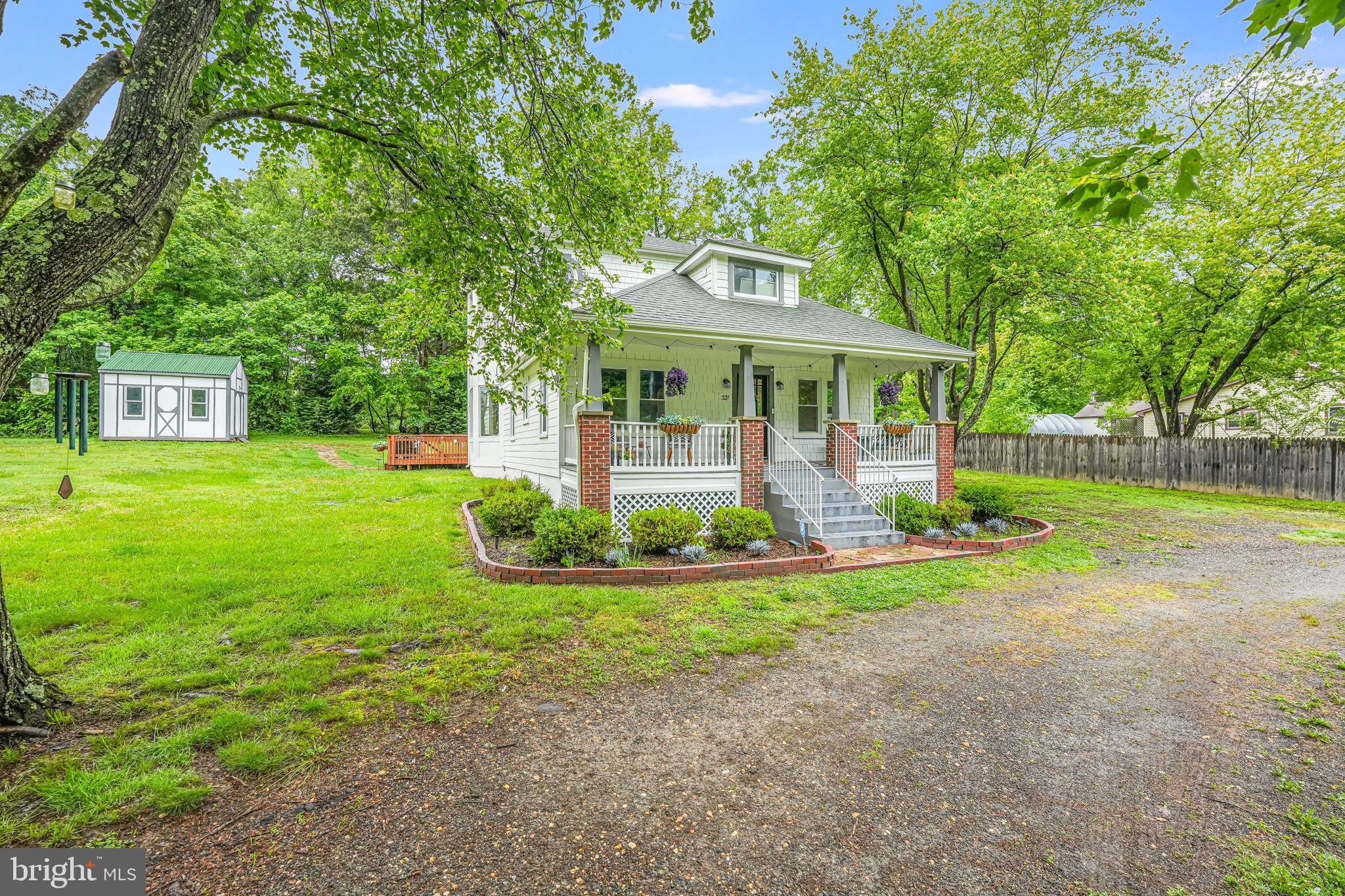 a front view of a house with yard and green space