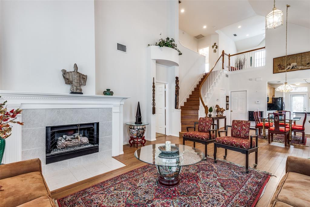 a living room with furniture a fireplace and a table