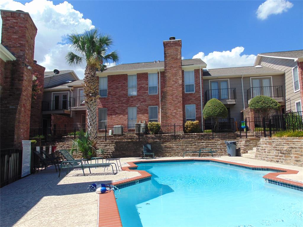 a front view of a house with swimming pool and patio