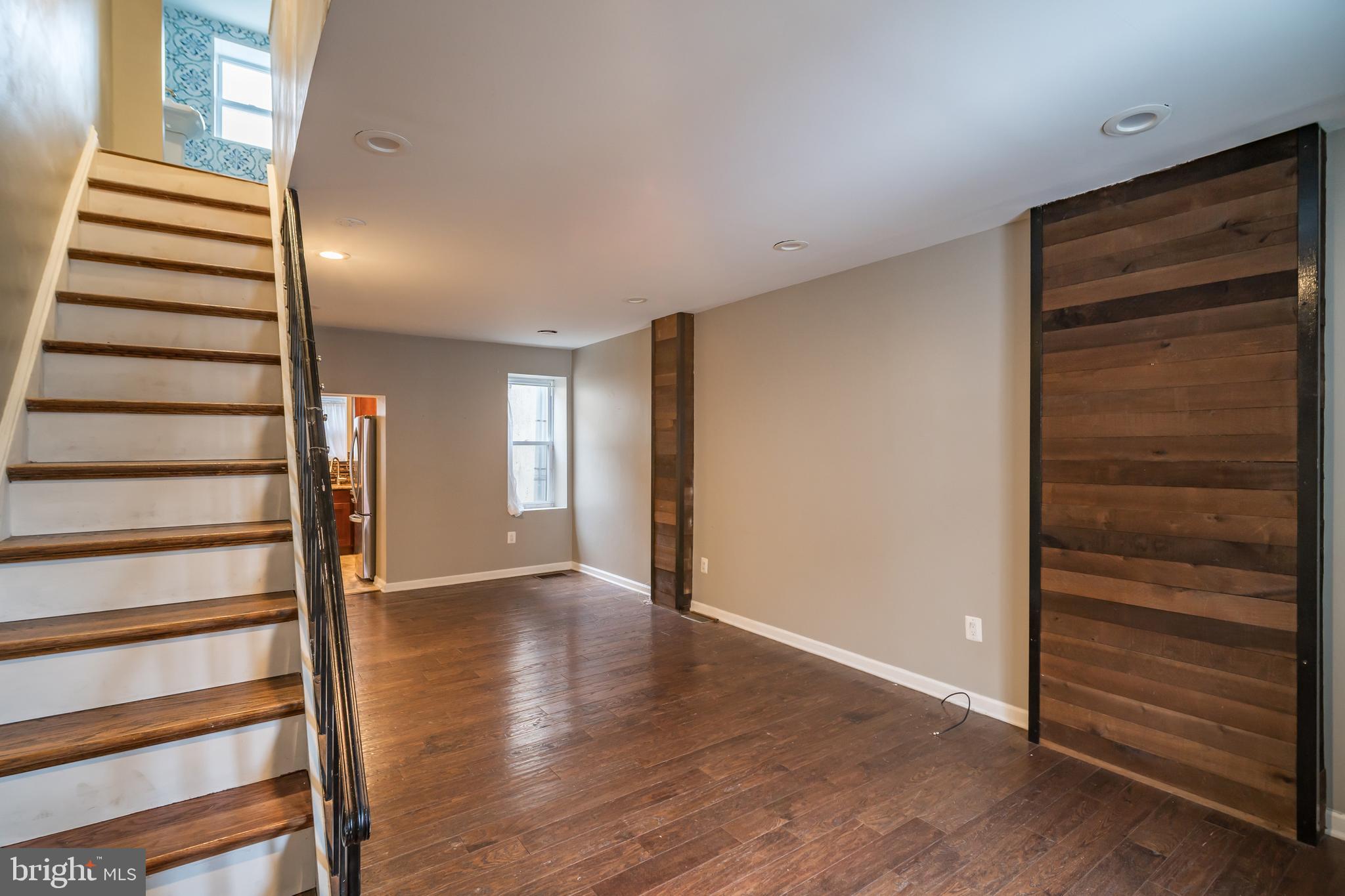 a view of a room with stairs and wooden floor