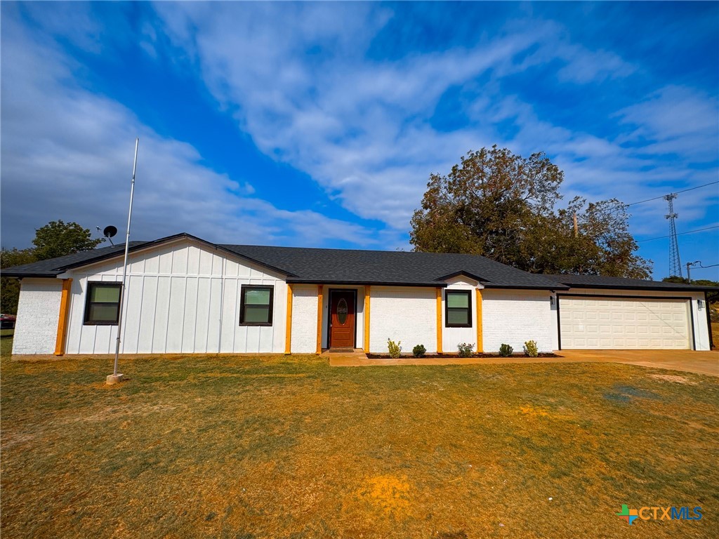 a front view of a house with a big yard