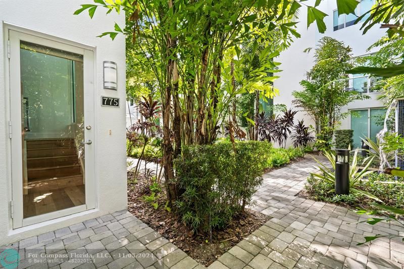 a couple of potted plants in front of door