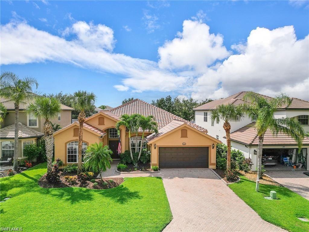 Mediterranean / spanish house with a front yard