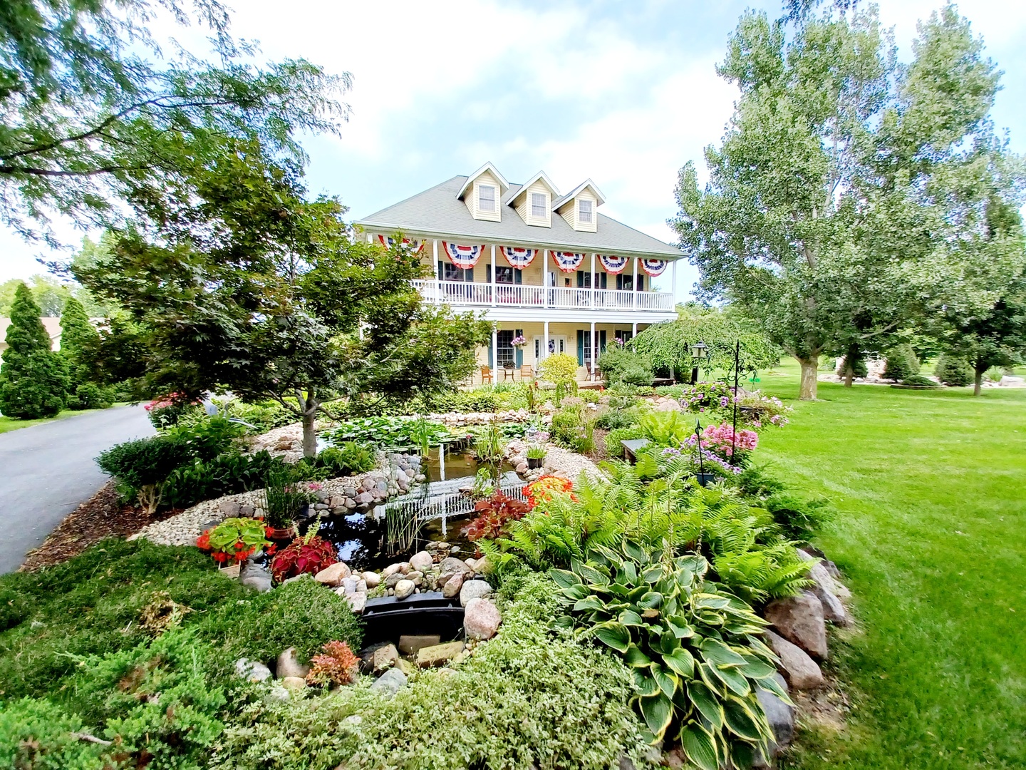 a view of a house with a yard and garden