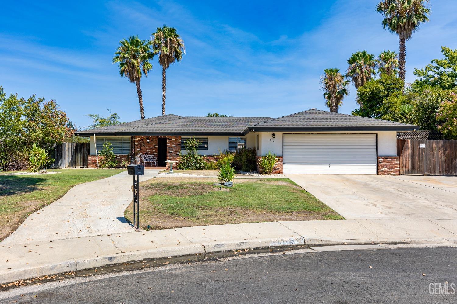 a front view of a house with a yard and a garage