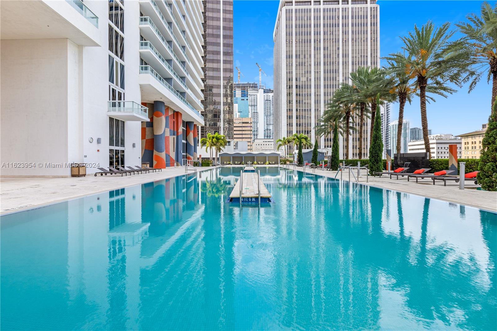 a swimming pool with outdoor seating and yard