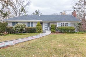 front view of house with yard and trees around