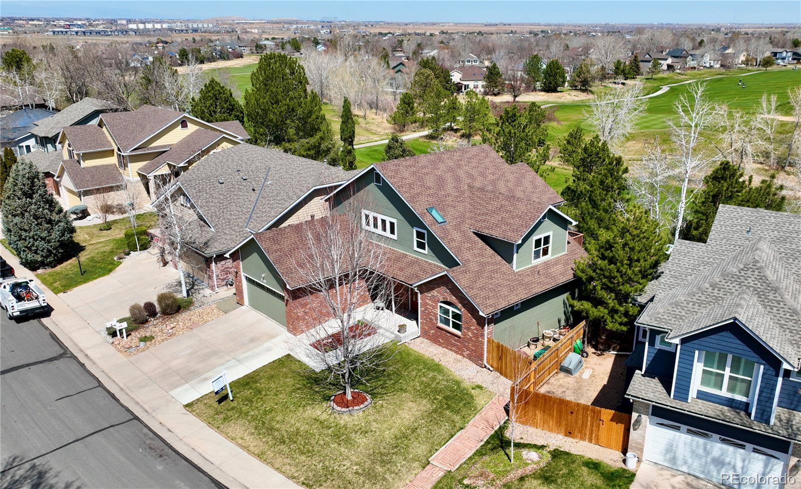 an aerial view of residential houses with outdoor space and parking