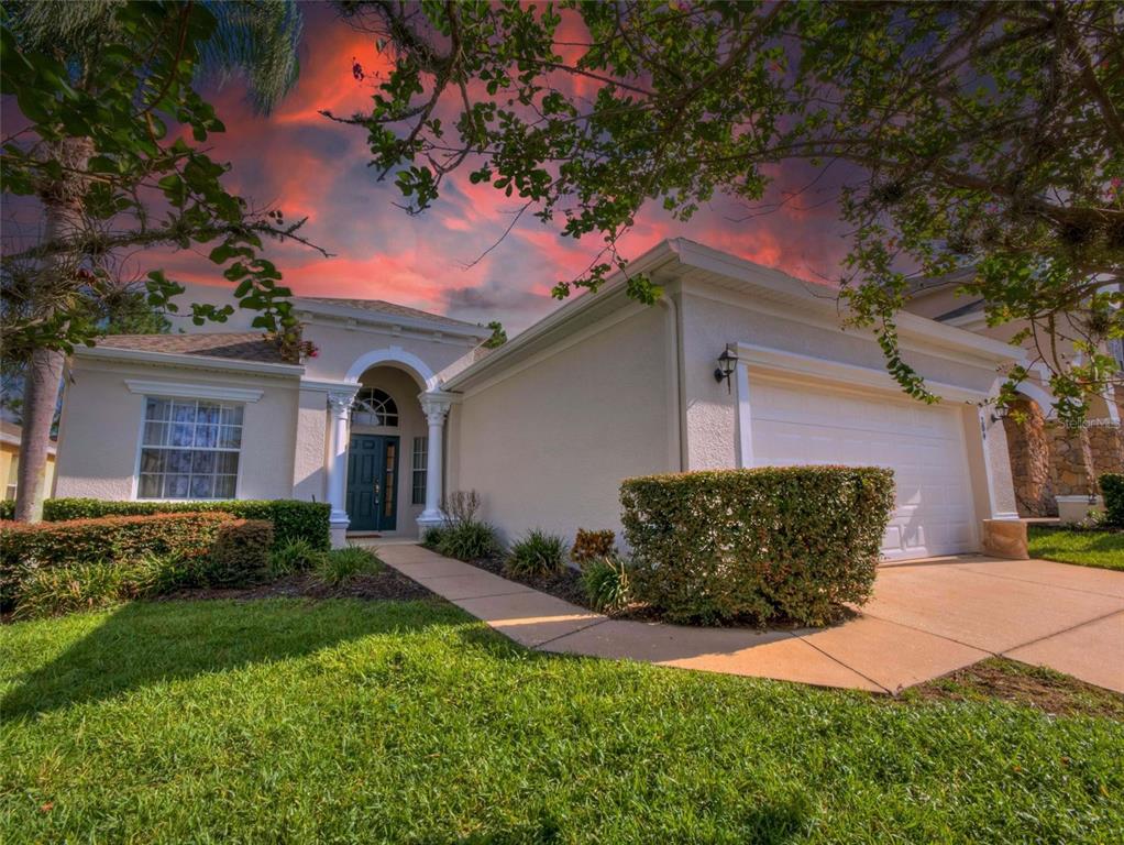 a front view of a house with a yard and garage