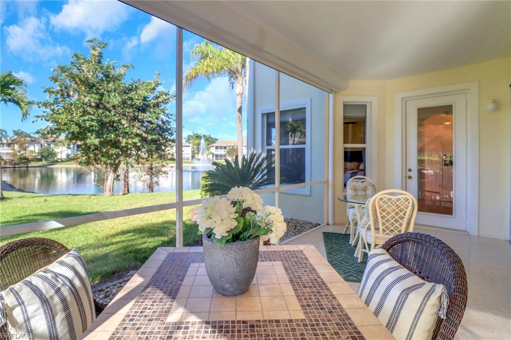 Sunroom featuring a water view