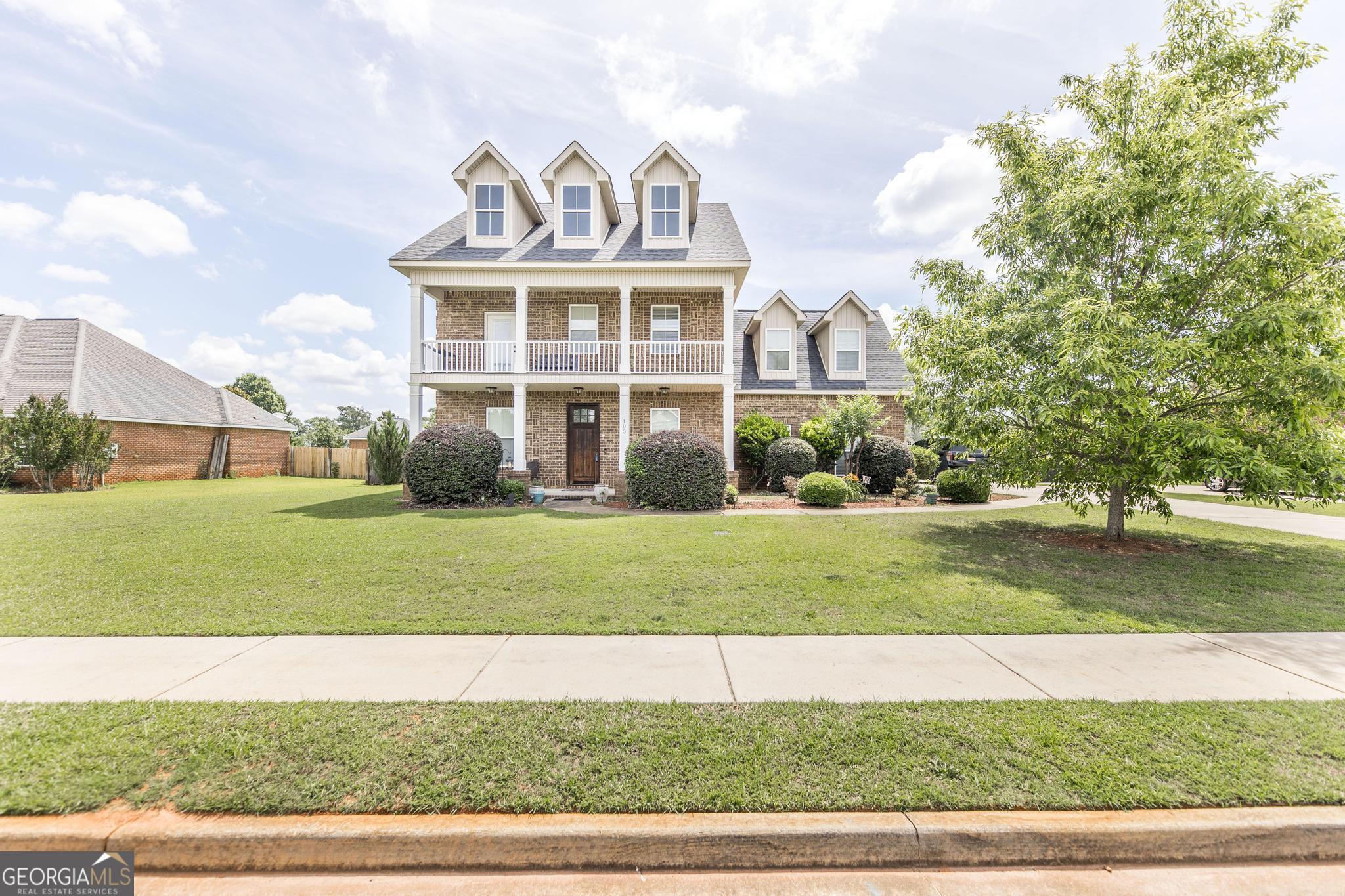 a front view of a house with a yard