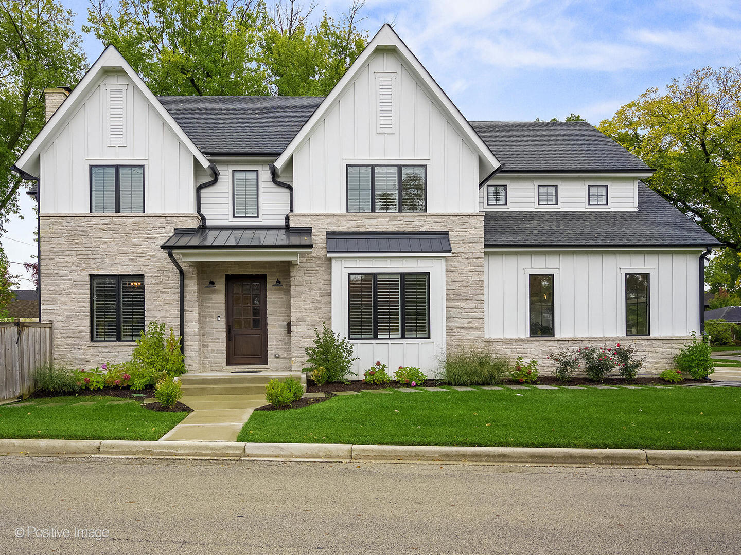 a front view of a house with a garden and garage