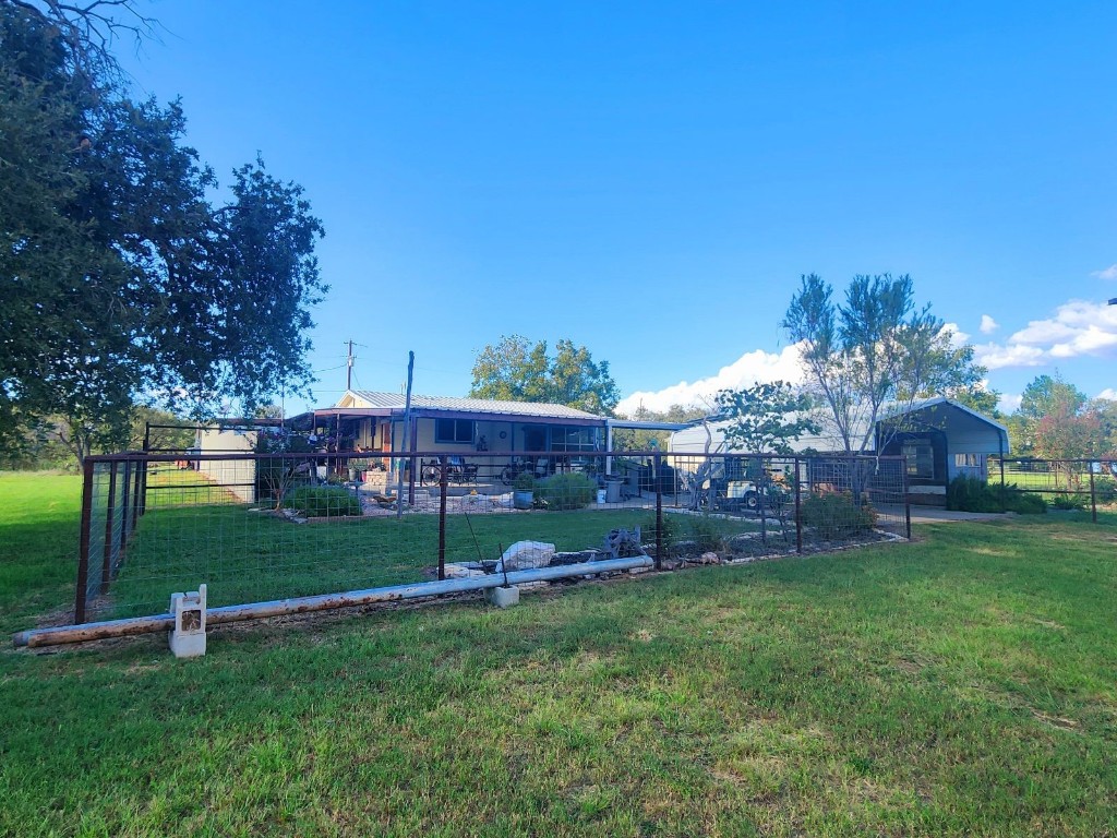 a view of yard with grass and a fountain