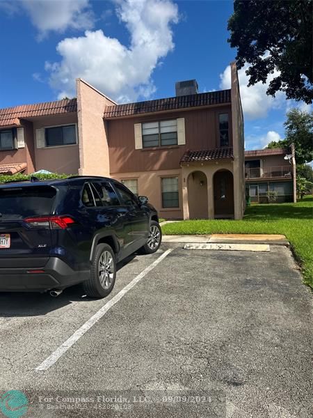 a view of a car parked in front of a house