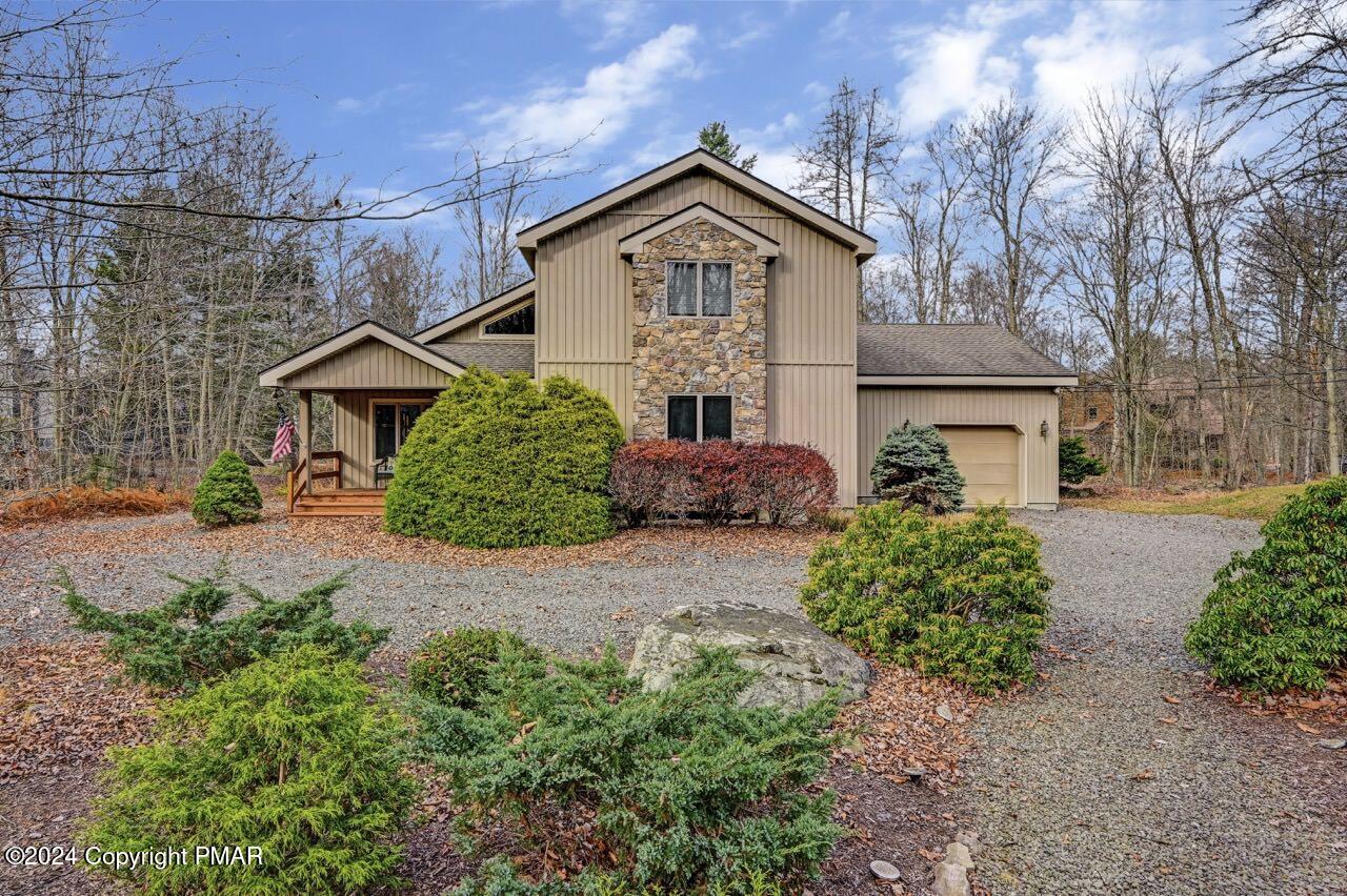 a front view of a house with garden