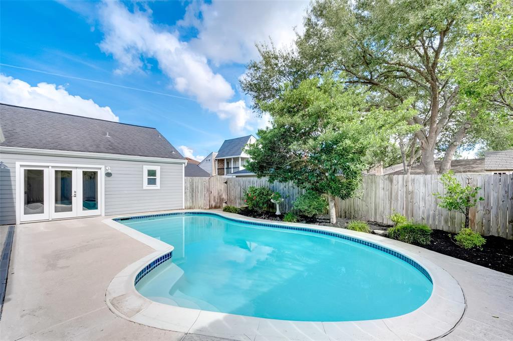 a view of a backyard with a swimming pool