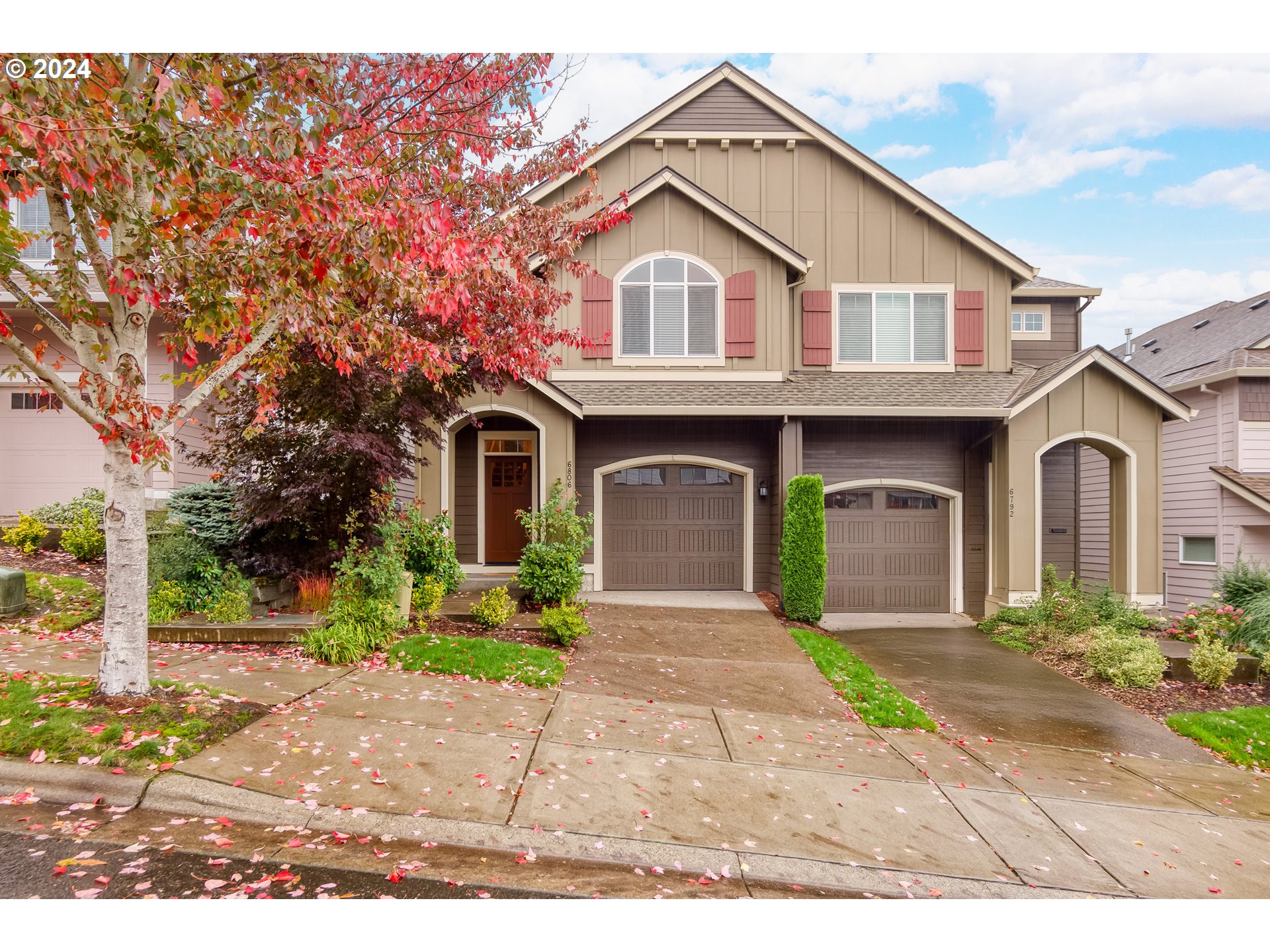 a front view of a house with a yard and a garage