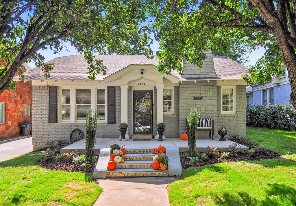 a front view of a house with garden and porch