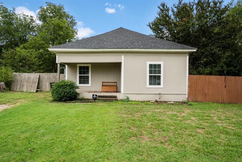 a house that has a big yard with wooden fence