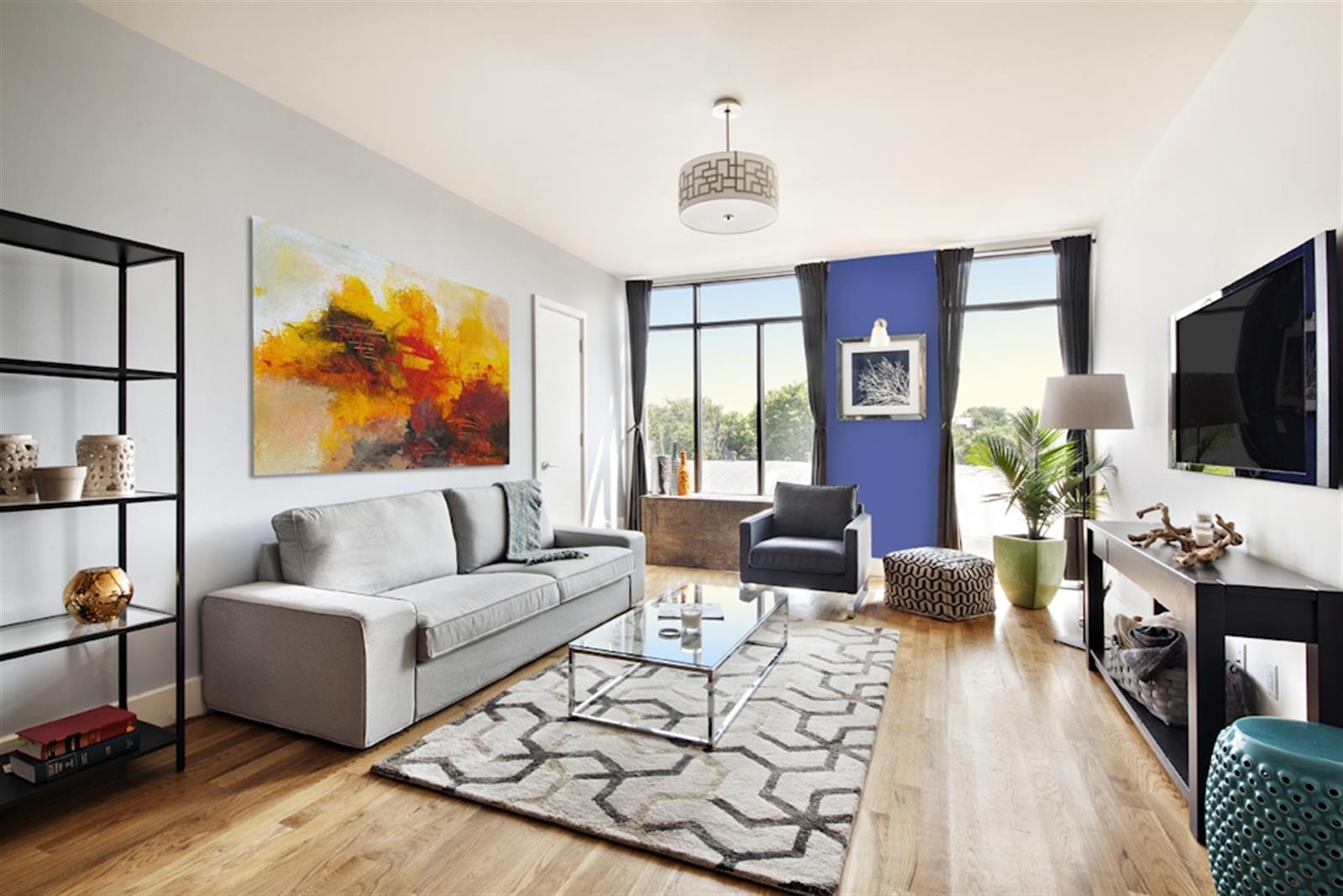 a living room with furniture a flat screen tv and a large window