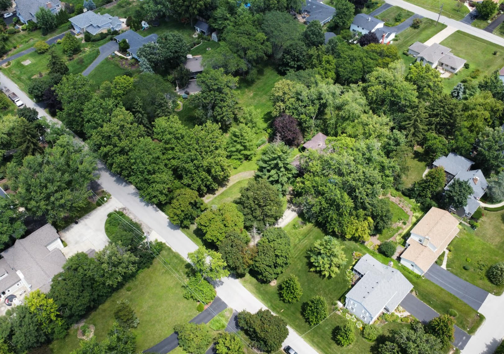 an aerial view of a house with yard