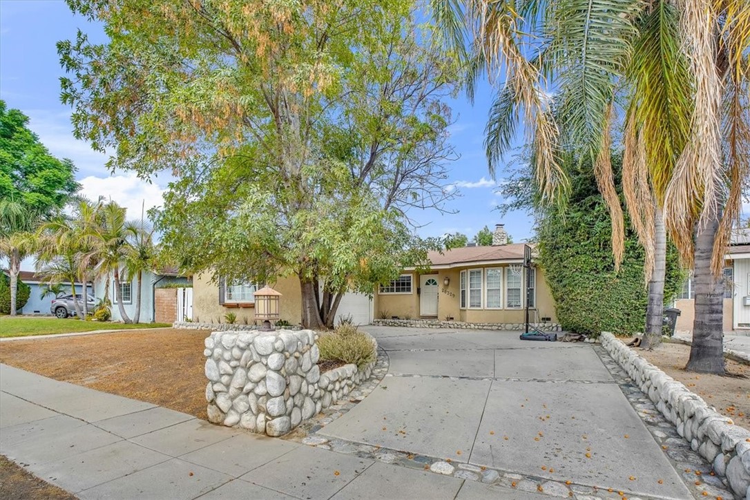 a view of a house with a tree in front