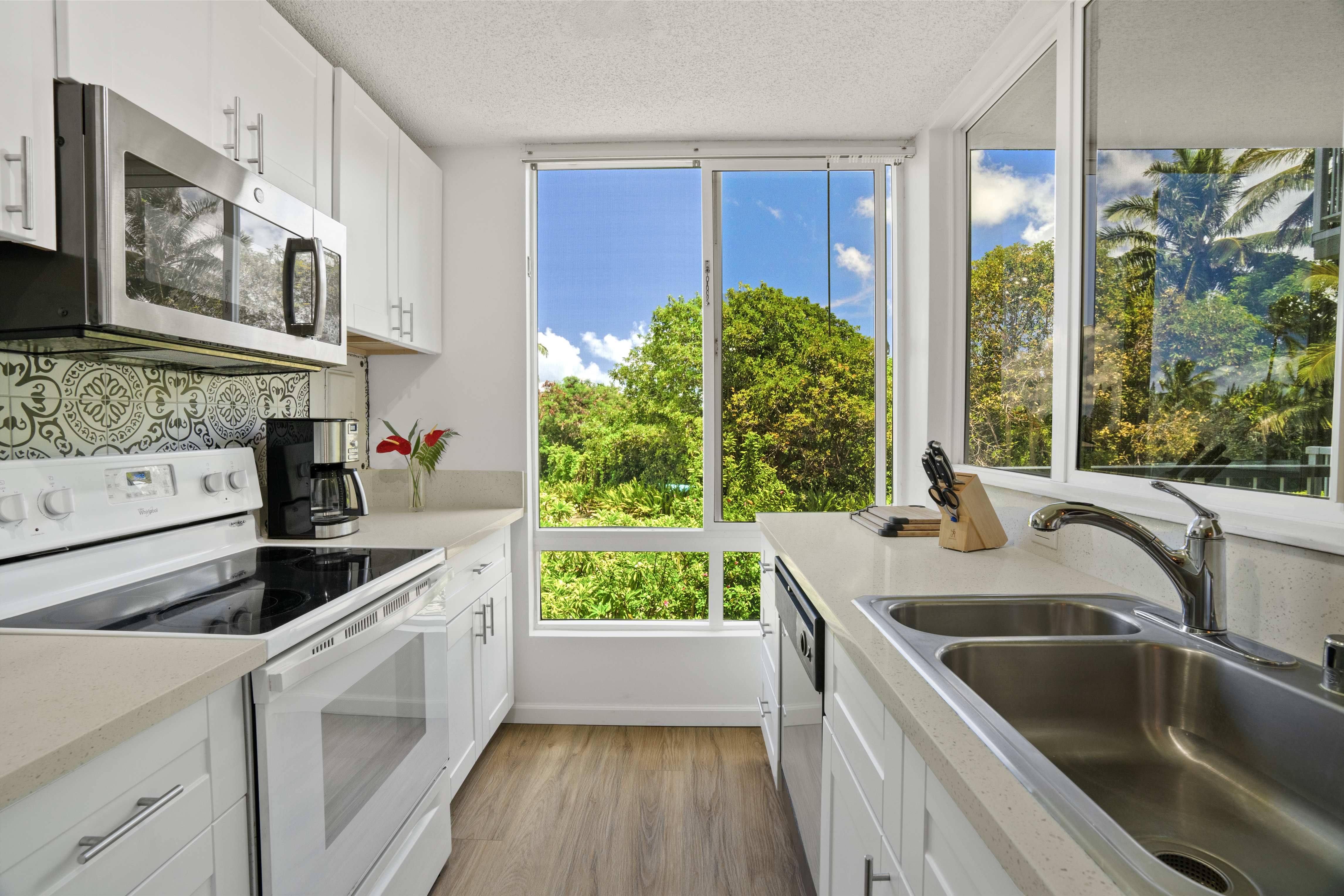 a kitchen with a sink stove and microwave