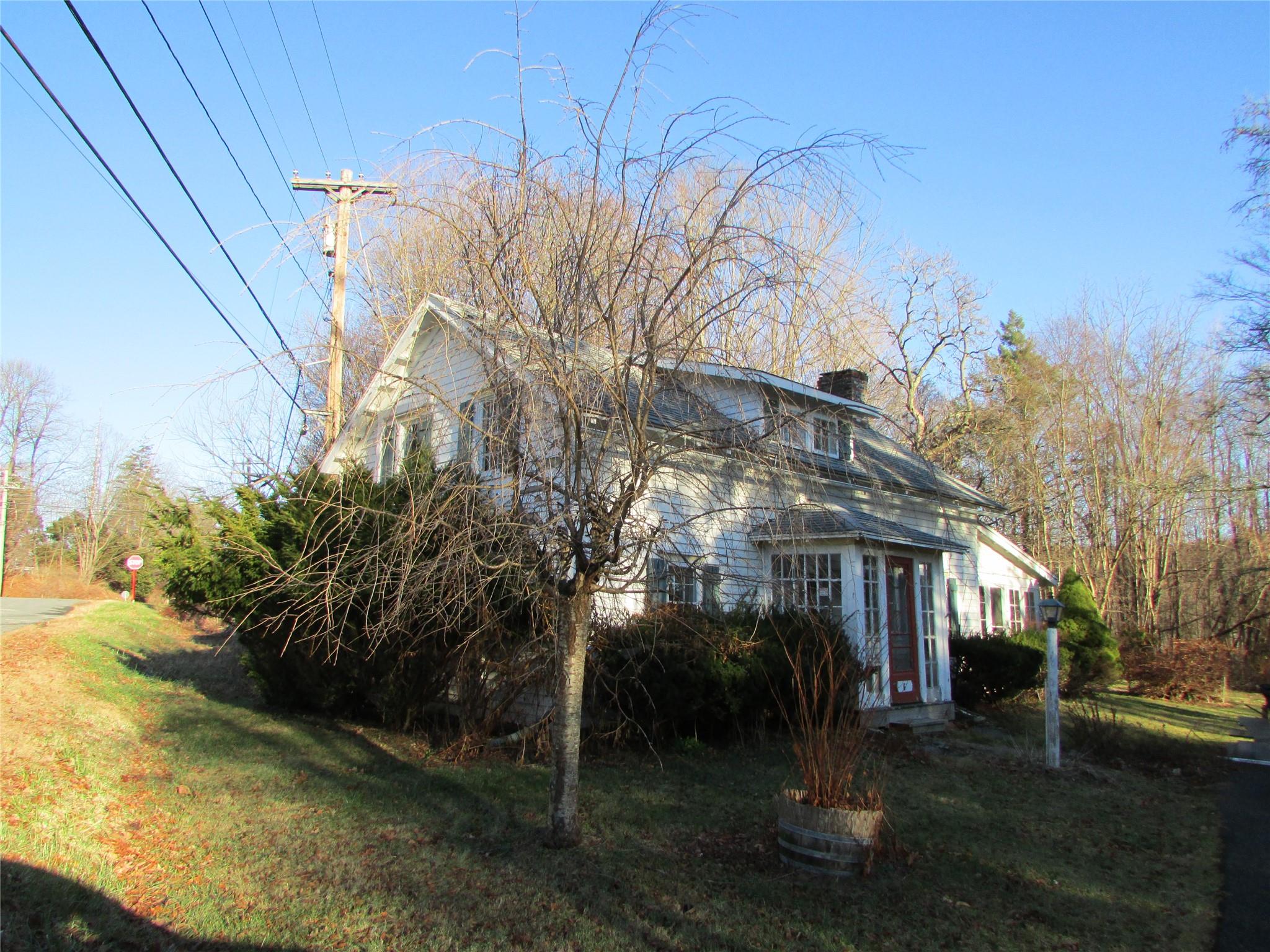 View of side of home with a lawn