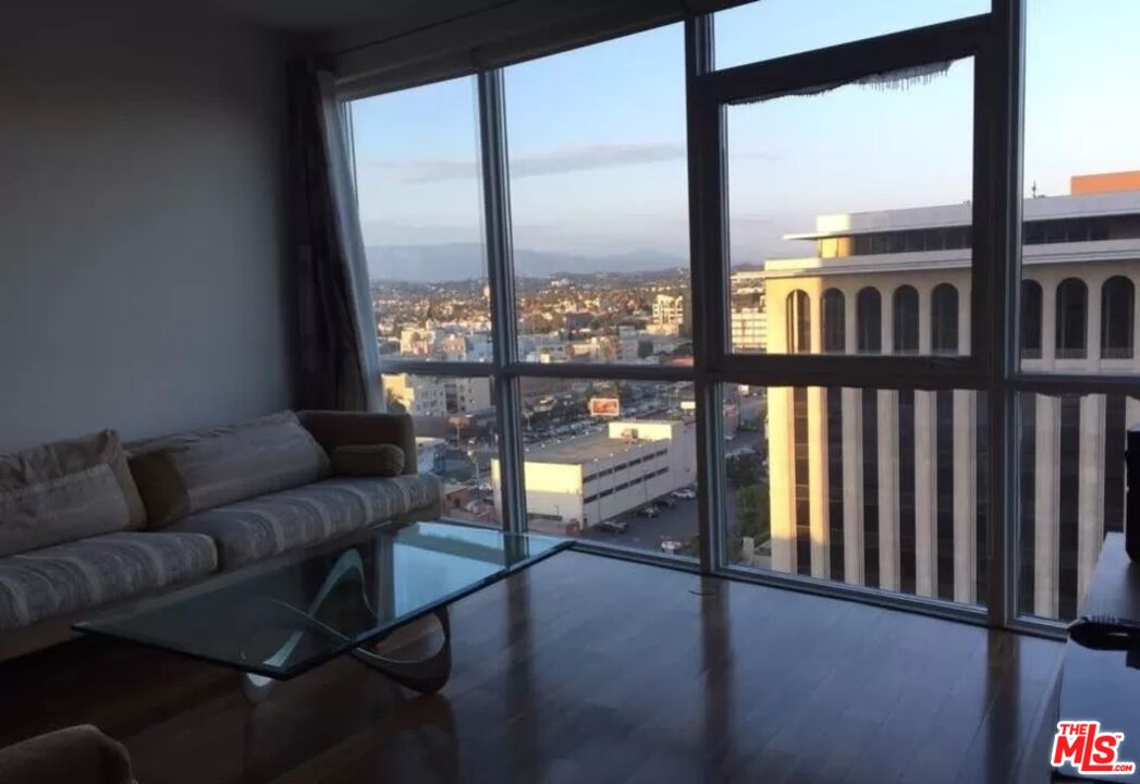 a living room with furniture and a floor to ceiling window