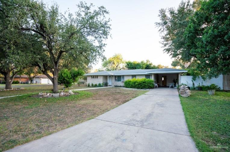 a front view of a house with a yard and a garage