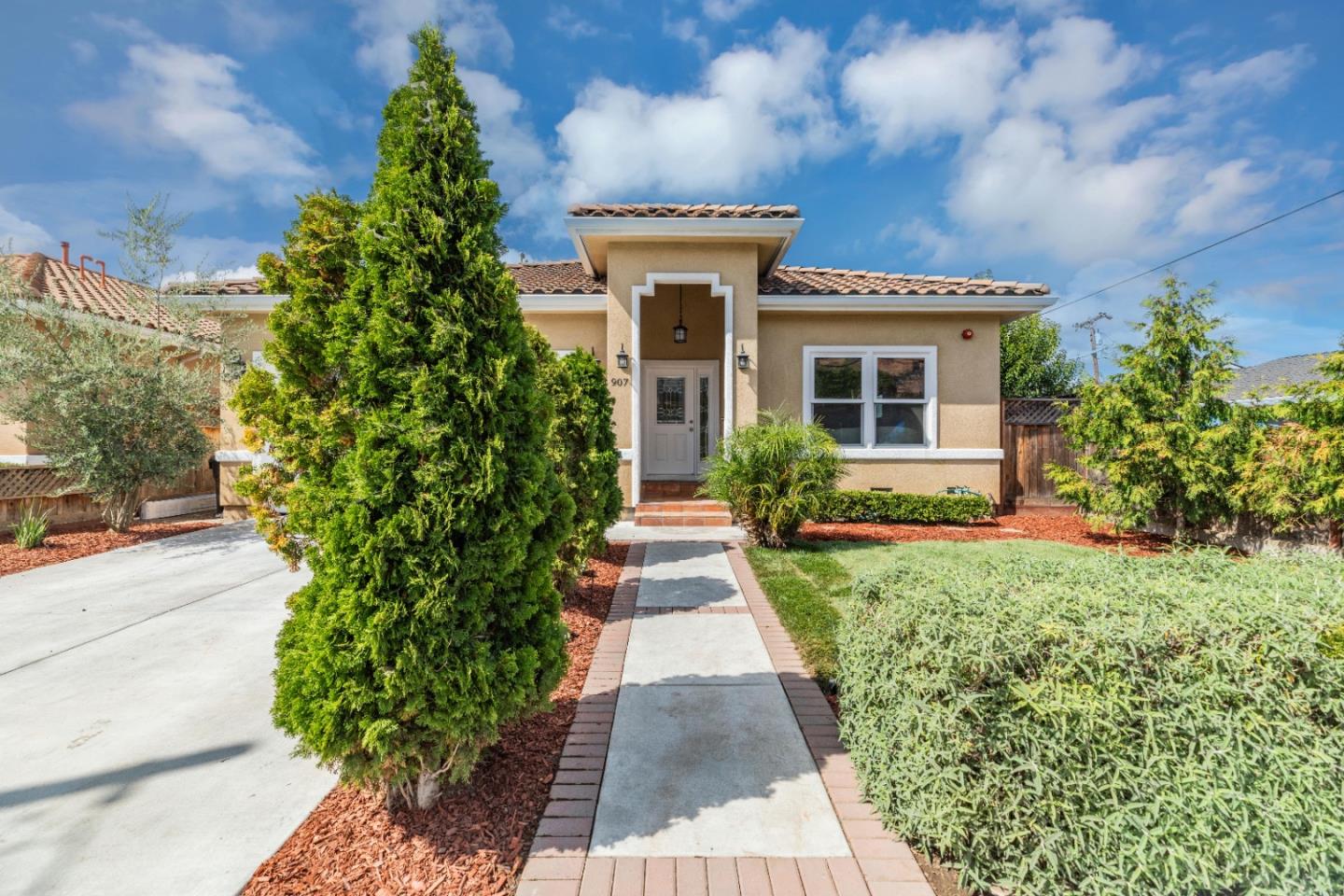 a front view of a house with garden