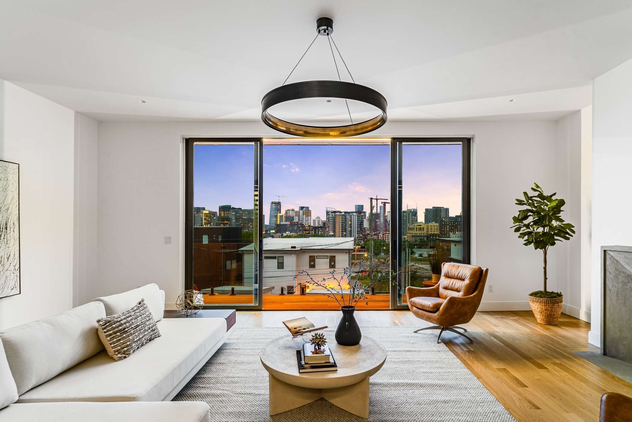 a living room with patio area and a large window