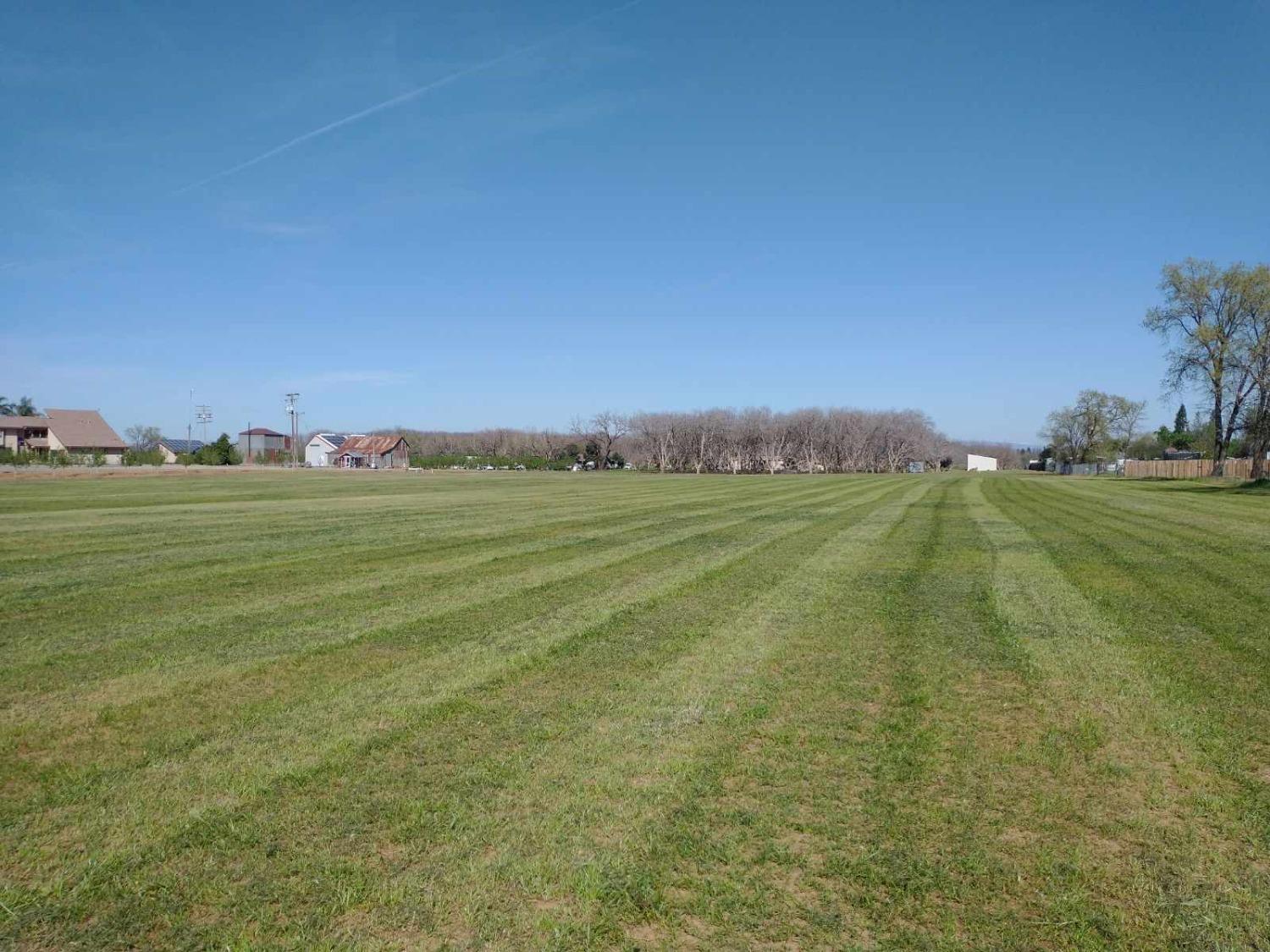 a view of a field with an outdoor space and seating