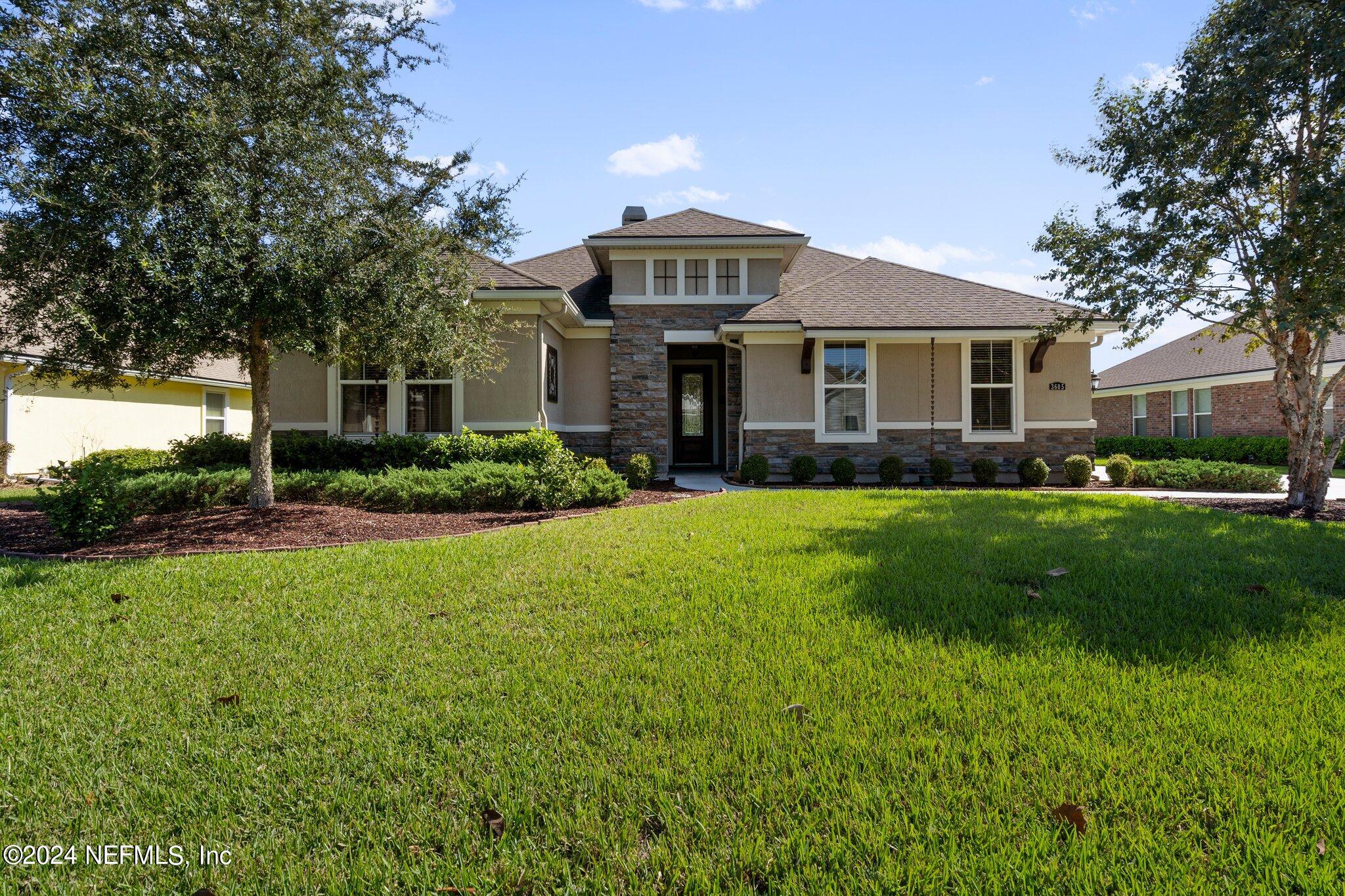 a front view of house with yard and green space