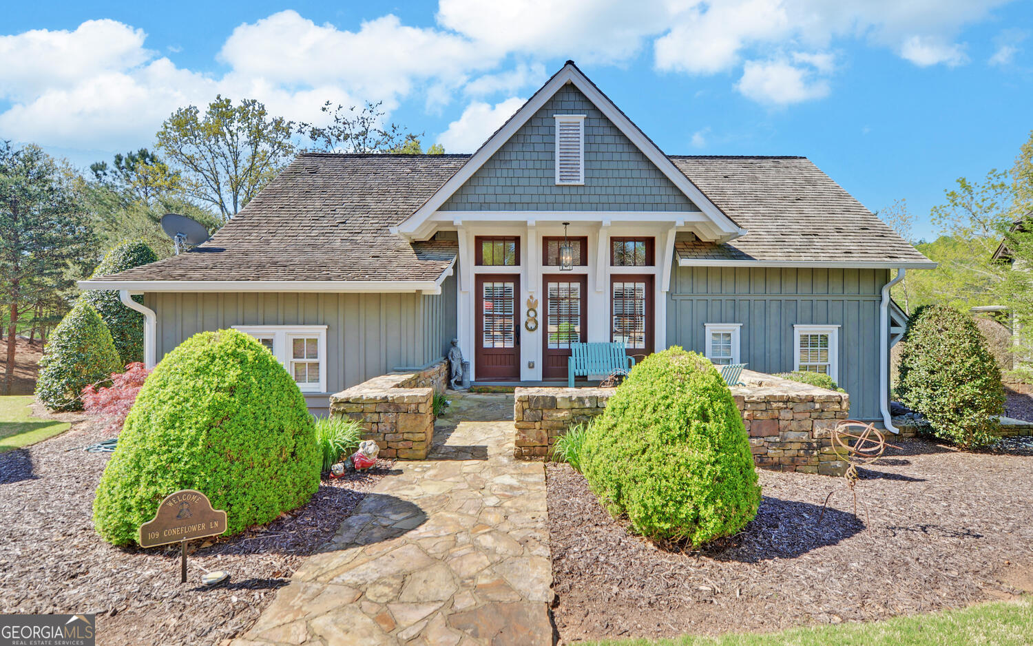 a front view of a house with garden