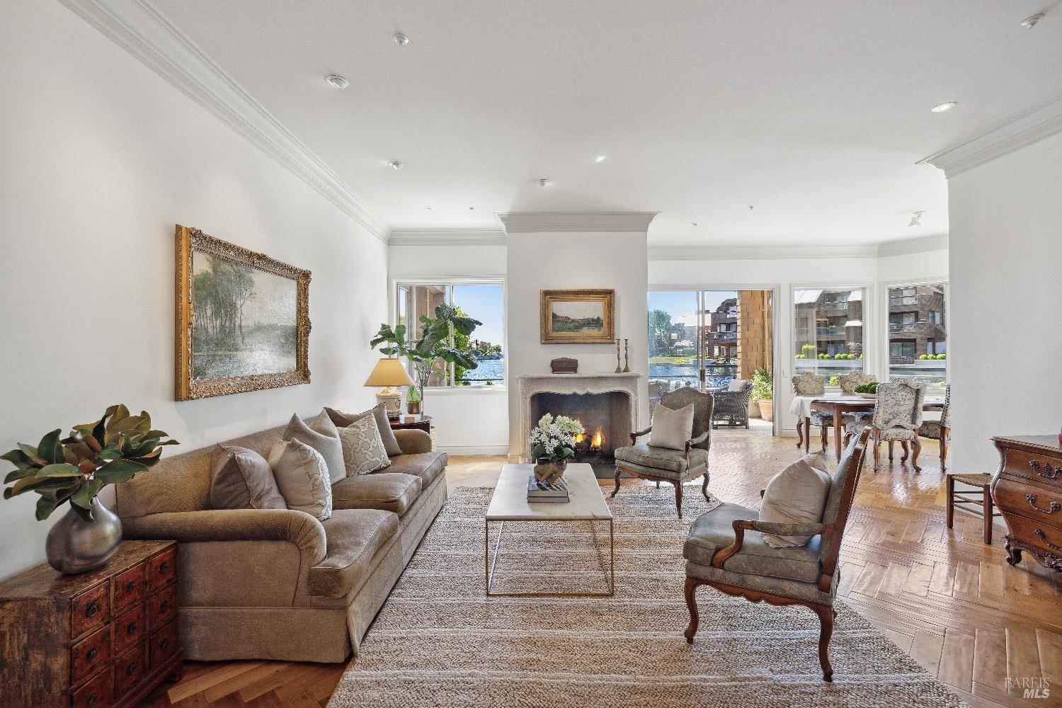 a living room with furniture wooden floor and a view of kitchen