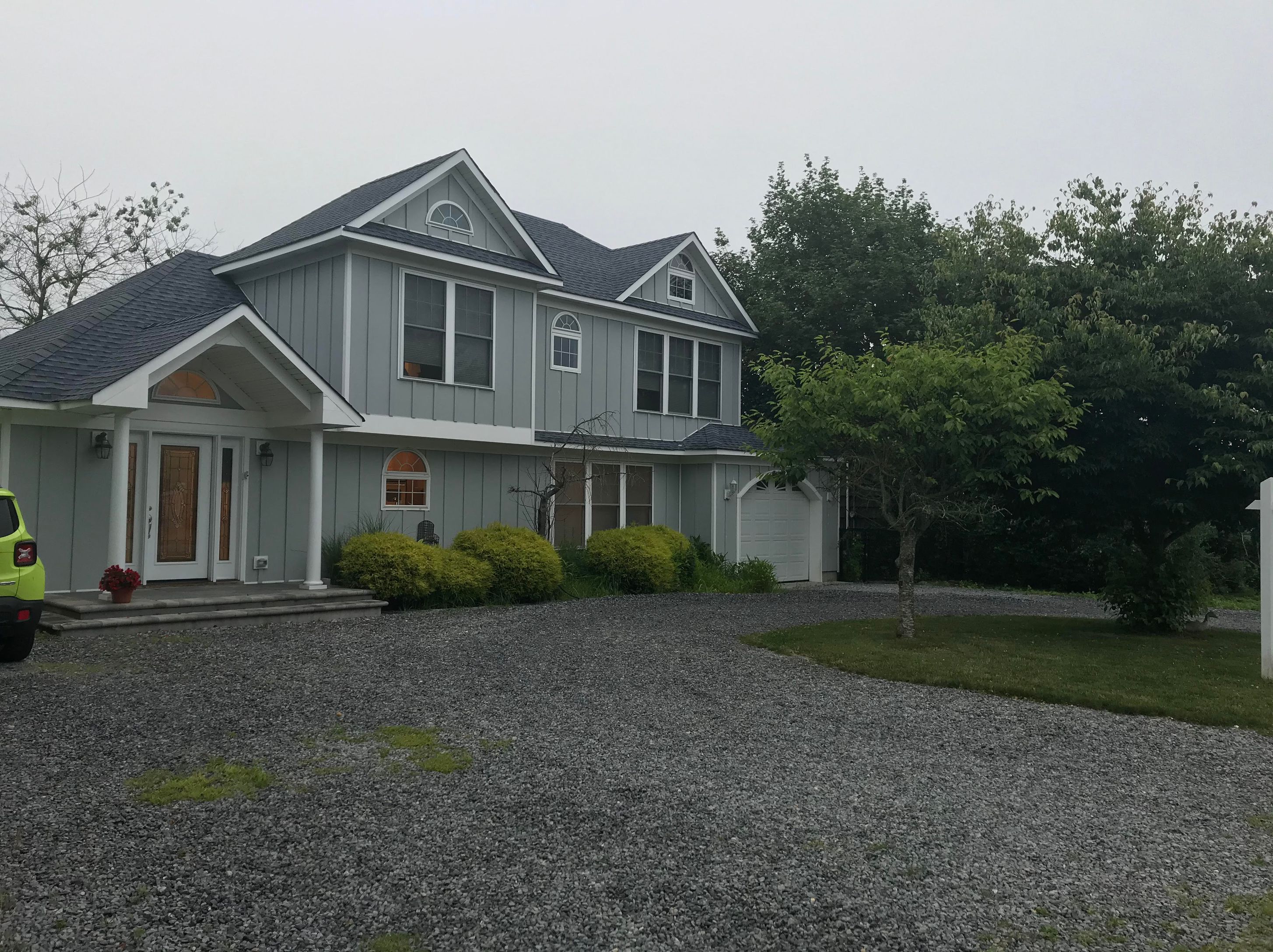 a front view of a house with a garden