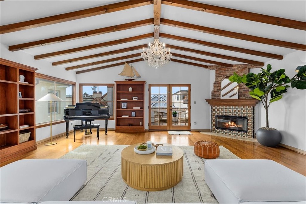 a living room with furniture a chandelier and a fireplace